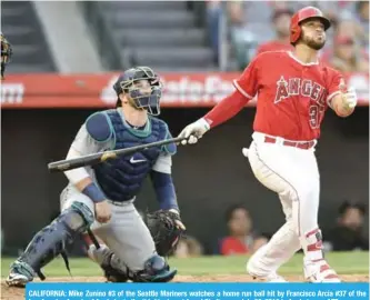  ?? — AFP ?? CALIFORNIA: Mike Zunino #3 of the Seattle Mariners watches a home run ball hit by Francisco Arcia #37 of the Los Angeles Angels of Anaheim in the third inning at Angel Stadium on July 28, 2018 in Anaheim.