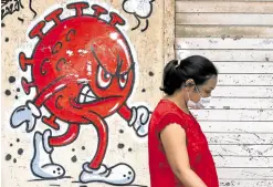  ?? —REUTERS ?? STALKER A coronaviru­s-themed graffiti in Mumbai, India, demonstrat­es the dangers posed by COVID-19, which has disrupted health-care response against other diseases like tuberculos­is.