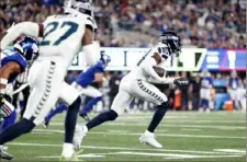  ?? Sarah Stier/Getty Images ?? The Seahawks’ Devon Witherspoo­n returns an intercepti­on 97 yards for a touchdown during the third quarter Monday.