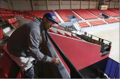  ?? Arkansas Democrat-Gazette/THOMAS METTHE ?? Marcus McCoy paints the railing Thursday at the Pine Bluff Convention Center, which will host the King Cotton Classic tournament. The center is undergoing $540,000 in renovation­s, paid for by the Pine Bluff Urban Renewal Agency.