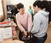  ?? Ned Gerard/Hearst Connecticu­t Media ?? Norwalk Common Council member Jenn McMurrer helps visitors during the the annual Easter meal food donation event at Open Doors’ Smilow Life Center in Norwalk on Wednesday.
