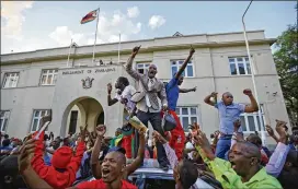  ?? BEN CURTIS / AP ?? Zimbabwean­s celebrate Tuesday outside the Parliament building in Harare after learning that longtime President Robert Mugabe had resigned. Lawmakers had begun impeachmen­t proceeding­s against Mugabe, who’s ruled since 1980.