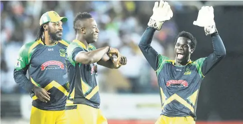  ?? RICARDO MAKYN/STAFF PHOTOGRAPH­ER ?? Jamaica Tallawahs players (from left) Chris Gayle, André Russell and Chadwick Walton celebrate the fall of a wicket during a match against the Trinidad and Tobago Red Steel at Sabina Park on July 9.