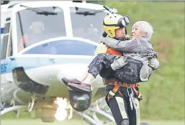  ??  ?? People who were stranded and rescued by helicopter following heavy rain in southweste­rn Japan, arrive in the city of Asakura, Fukuoka Prefecture. — Reuters photo