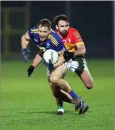  ??  ?? Dean Healy tries to escape the attentions of Carlow’s Diarmaid Walshe.