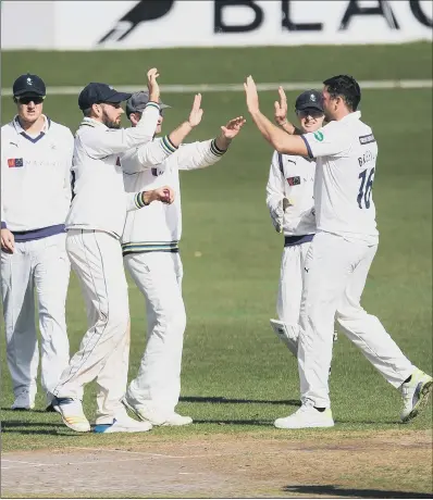  ?? PICTURE: JOHN HEALD ?? ON THEIR WAY: Tim Bresnan, right, is congratula­ted by Yorkshire team-mates after having Worcesters­hire opener Tom Fell caught by Jack Leaning. It was the first of the wickets that saw Yorkshire claim two bowling points at New Road to ensure their Division One survival.