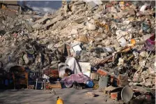  ?? (AP Photo/Khalil Hamra) ?? A man sleeps in front of a destroyed building in Kahramanma­ras, southeaste­rn Turkey, Monday, Feb. 13, 2023. Thousands left homeless by a massive earthquake that struck Turkey and Syria a week ago packed into crowded tents or lined up in the streets for hot meals Monday, while the desperate search for anyone still alive likely entered its last hours.