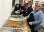  ?? BY GLENN GRIFFITH — THE SARATOGIAN ?? Volunteers preparing plates of food for the Ballston Spa Thanksgivi­ng Meal Thursday at the Union Fire Company No. 2 firehouse.