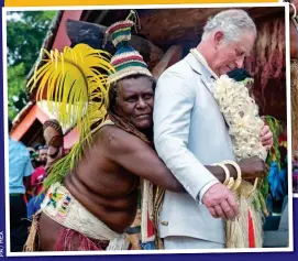  ??  ?? FINISHING TOUCH: The Prince also got a giant palm leaf to wear with his ‘Paramount Chief’ attire on the island of Vanuatu. Left: Being helped into his outfit