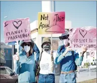  ?? ?? Abortion rights supports stand outside the courthouse on Saturday afternoon.