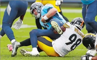  ?? WADE PAYNE/AP PHOTO ?? Titans quarterbac­k Ryan Tannehill is sacked by Pittsburgh’s Vince Williams during Sunday’s game.