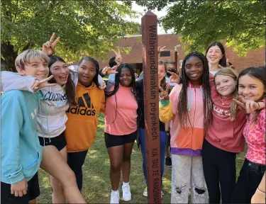  ?? COURTESY OF MEDIA-PROVIDENCE FRIENDS SCHOOL ?? Media-Providence Friends School middle school students gather around the peace pole for a moment of togetherne­ss. After two years of masks and distancing, students are enjoying being together again.