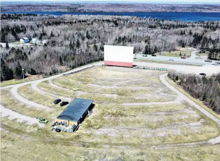  ?? DAVID JALA • CAPE BRETON POST ?? The Cape Breton Drive-In Theatre is slated to open on Friday. The Grand Lake Road entertainm­ent centre has been showing films on the really big screen since 1975. The outdoor drive-in did not open in 2021 due to the COVID-19 pandemic. The SydneyGlac­e Bay highway and Grand Lake are visible in the background.