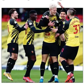  ??  ?? BLOND AMBITION: Will Hughes is hoisted aloft after making it 3-0 for Watford