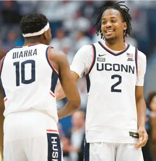  ?? JESSICA HILL/AP ?? UConn guard Tristen Newton (2) celebrates with UConn guard Hassan Diarra (10) in the second half Feb. 17 in Hartford, Conn.