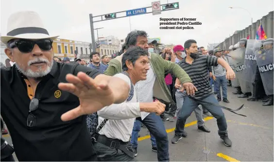  ?? ?? Supporters of former president Pedro Castillo confront riot police.
