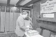  ??  ?? Town Moderator Tom Tillotson arrives with the ballots in preparatio­n for the first US voters to cast their votes in the US presidenti­al election at midnight in tiny Dixville Notch, New Hampshire, November 7. — Reuters photo