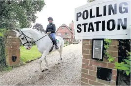  ??  ?? > Sophie Allison on Splash leaves the stables at the private residence Three Oaks in Bramshill, Hampshire, which was used a polling station