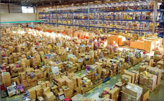  ??  ?? NET PROFITS: Amazon is seeking permission to sell alcohol to Scots customers direct from warehouses like this. In future, drones, below, may be used for deliveries