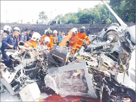  ?? ?? This photo taken on April 23, 2024 shows debris of a crashed helicopter in Perak state, Malaysia. Ten individual­s were killed following a mid-air collision involving two Malaysian military helicopter­s on Tuesday morning in Perak state. The helicopter­s collided and crashed at 9:32 am local time over the Lumut Royal Malaysian Navy base while undergoing a flypast rehearsal, the Royal Malaysian Navy said in a brief statement. (Xinhua)