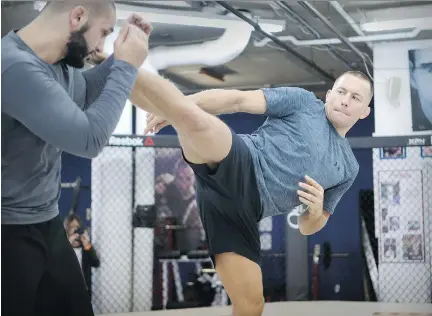  ?? JOHN MAHONEY ?? Georges St-Pierre spars with his head trainer, Firaz Zahabi, at Montreal’s Tristar Gym on Wednesday. When St-Pierre enters the octagon Nov. 4 to take on Michael Bisping at Madison Square Garden, it will have been four years, nearly to the day, since...