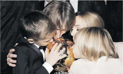 ?? Picture: Reuters ?? FAMILY AFFAIR. Ballon d’Or winner Luka Modric (centre), his wife Vanja, his son Ivano and his daughter Ema kiss the trophy the Croatian lifted in Paris on Monday night.