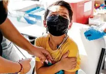  ?? Sam Owens / Staff photograph­er ?? Hector Mancha, 8, worries that getting a COVID shot will hurt. He was getting his shot at a Hidalgo pop-up clinic this month.