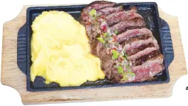  ?? ?? Meat the winner: Robatagril­led steak slices with truffled mashed potatoes and Peruvian chalaquita