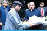  ?? ?? ISLAMABAD: This handout photograph by Pakistan’s Press Informatio­n Department shows the country’s newly sworn-in Prime Minister Shehbaz Sharif greeting their newly-elected President Asif Ali Zardari. — AFP