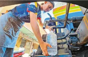  ?? ?? a file picture showing a hawker getting water supply from PBAPP’S water tanker last month. Tankers will be on standby to supply water during the scheduled water cut from tomorrow to Jan 14.