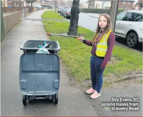  ??  ?? Sky Evans, 10, picking masks from Staveley Road