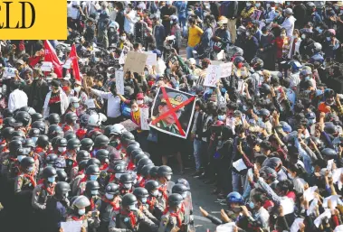  ?? THE ASSOCIATED PRESS ?? Protesters face rows of riot police in Naypyitaw, Myanmar, on Monday, as tens of thousands took to the streets for a third day of protests against last week's coup that overthrew the civilian government.