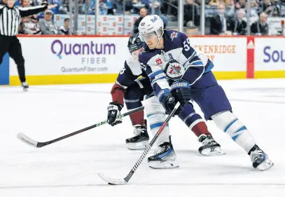  ?? ISAIAH J. DOWNING • USA TODAY SPORTS ?? Winnipeg Jets centre Mark Scheifele controls the puck ahead of Colorado Avalanche defenceman Cale Makar in the first period at Ball Arena.