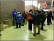  ?? SUBMITTED PHOTO ?? Chester Upland School of the Arts students try on coats as members of the Auto Dealers CARing for Kids Foundation distribute them during Friday’s Driving Away the Cold event at Chester High School.