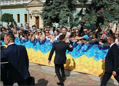  ?? AP/EVGENIY MALOLETKA ?? Ukrainian President-elect Volodymyr Zelenskiy greets supporters before inaugurati­on ceremony Monday in Kiev, Ukraine.