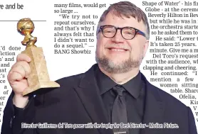  ?? - Motion Picture. ?? Director Guillermo del Toro poses with the trophy for Best Director