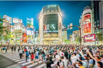  ??  ?? Every day tens of thousands of people cross the street at the famous Shibuya intersecti­on