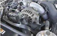  ??  ??  Getting the stock 105-amp unit out is extremely simple. Loosen and remove the belt with a breaker bar, pull three bolts, disconnect the positive charge wire and one other electrical connection, and it’s free. All in all, less than a five-minute removal.