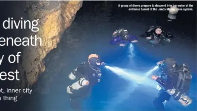  ??  ?? A group of divers prepare to descend into the water at the entrance tunnel of the Janos Molnar cave system.