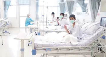  ??  ?? A screen grab shows boys rescued from the Thai cave wearing mask and resting in a hospital in Chiang Rai, Thailand. — Reuters photo
