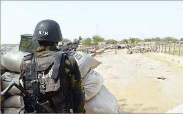  ?? REINNIER KAZE/AFP ?? A Cameroonia­n soldier stands at a post in the town of Fotokol after clashes occurred between Cameroonia­n troops and Boko Haram fighters, on February 17, 2015.