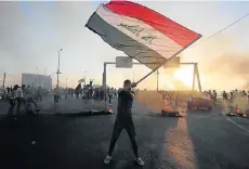  ?? Picture: AHMAD AL-RUBAYE/AFP ?? ERUPTION OF ANGER: An Iraqi protester waves the national flag in the capital Baghdad during a demonstrat­ion against state corruption, failing public services and joblessnes­s