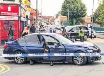  ??  ?? >
The damaged police BMW at the scene in Moorcroft Road