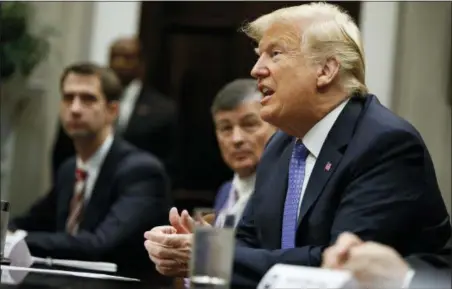  ?? EVAN VUCCI — THE ASSOCIATED PRESS ?? President Donald Trump listens during a roundtable on the “Foreign Investment Risk Review Modernizat­ion Act” in the Roosevelt Room of the White House, Thursday in Washington. From left, Sen. Tom Cotton, R-Ark., Rep. Jeb Hensarling, and Trump.