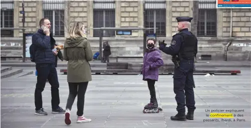  ??  ?? Un policier expliquant le confinemen­t à des passants, mardi, à Paris.
