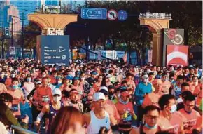  ?? AFP PIC ?? Runners taking part in the 2020 Shanghai marathon in Shanghai yesterday.