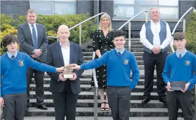  ??  ?? The winning Summerhill College team being presented with their trophy. Back: Eoin Moriarty (Summerhill College vice-principal), Dervilla Casey (teacher), Brian Dolan (SEP co-ordinator). Front: Thivaud Gerard, John Reilly (head of enterprise, Sligo County Council), Ben O’Loughlin and Patrick Donlon.