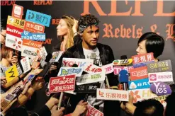  ?? — AFP ?? SHANGHAI: Brazilian footballer Neymar Jr. looks on as he speaks to media at a fashion event in Shanghai yesterday. Neymar hit the red carpet in Shanghai as speculatio­n mounted that the Brazil star could be set to quit Barcelona for Paris Saint-Germain...