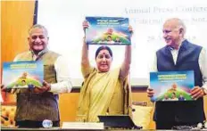  ?? PTI ?? Sushma Swaraj, flanked by ministers of state M.J. Akbar and ■ V.K. Singh, releases a publicatio­n on four years of NDA rule.