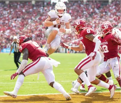  ?? NICK WAGNER/AP ?? Quarterbac­k Sam Ehlinger leaps into the end zone for one of his three rushing touchdowns in Texas’ upset of Oklahoma.